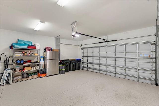 garage featuring stainless steel fridge and a garage door opener