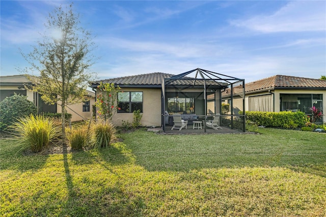 rear view of property with a patio, a lanai, and a lawn