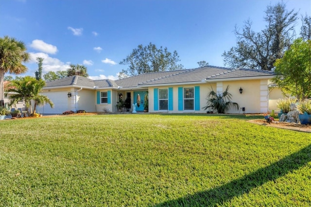 back of house with a garage and a lawn