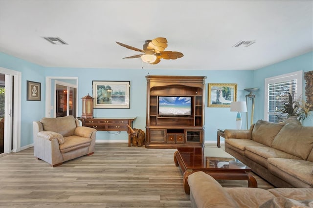 living room featuring ceiling fan and light hardwood / wood-style floors