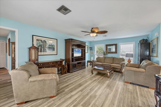 living room featuring ceiling fan and light hardwood / wood-style flooring