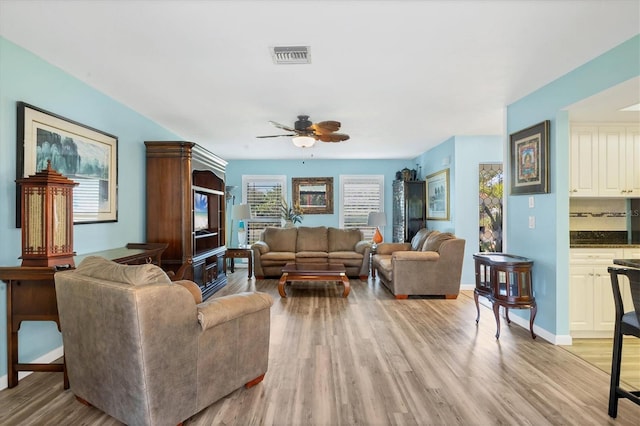 living room featuring ceiling fan and light wood-type flooring