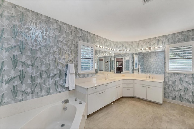 bathroom with tile patterned flooring, vanity, and a washtub