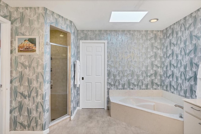 bathroom featuring shower with separate bathtub, a skylight, and tile patterned floors