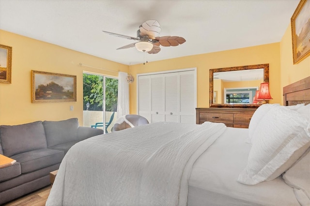 bedroom featuring wood-type flooring, a closet, access to outside, and ceiling fan