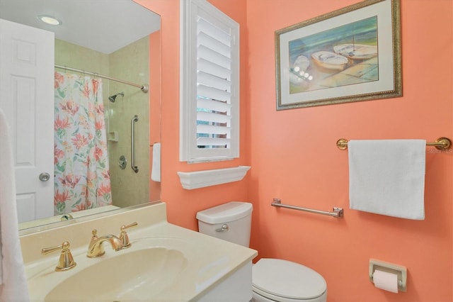 bathroom featuring curtained shower, sink, and toilet