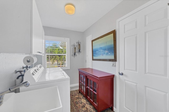 washroom with separate washer and dryer, sink, and cabinets