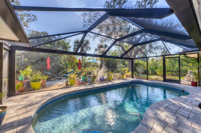 view of pool with a lanai and a patio area