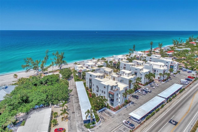 drone / aerial view featuring a beach view and a water view