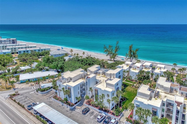 birds eye view of property with a water view and a view of the beach