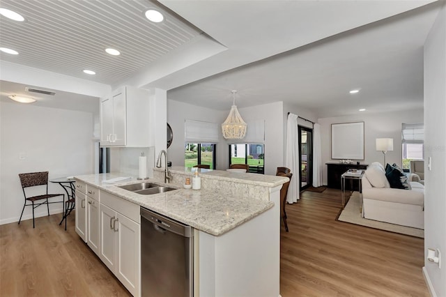 kitchen featuring a wealth of natural light, white cabinets, and stainless steel dishwasher