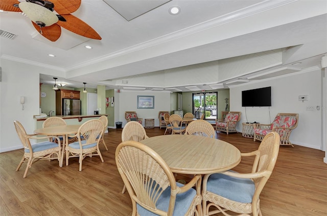 dining room featuring ceiling fan, light hardwood / wood-style floors, and crown molding