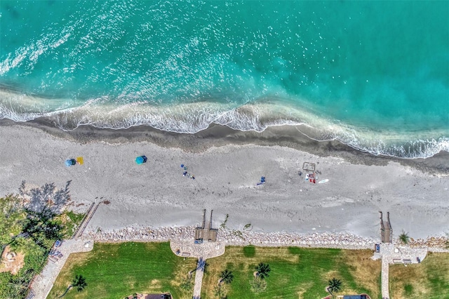 drone / aerial view featuring a water view and a beach view