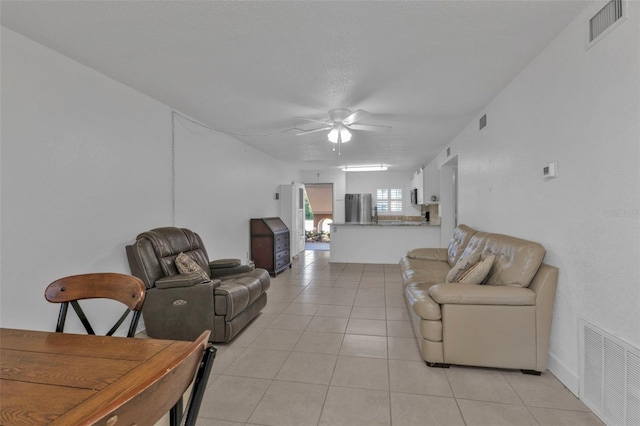 living room with ceiling fan and light tile patterned floors