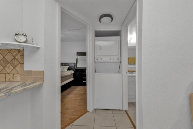 hallway featuring light hardwood / wood-style flooring and stacked washer and clothes dryer