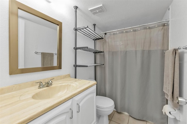 bathroom with walk in shower, tile patterned flooring, a textured ceiling, toilet, and vanity