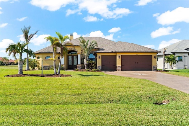 view of front of home featuring a garage, a front yard, and french doors