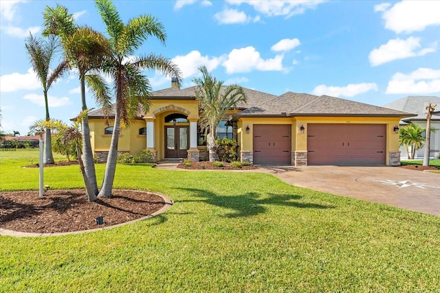 view of front of home featuring french doors, a garage, and a front lawn