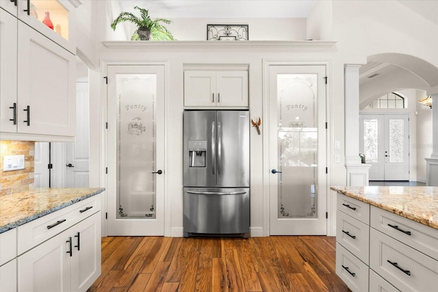 kitchen featuring white cabinets, stainless steel fridge, and french doors