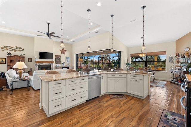 kitchen featuring pendant lighting, ceiling fan, light stone countertops, appliances with stainless steel finishes, and white cabinetry