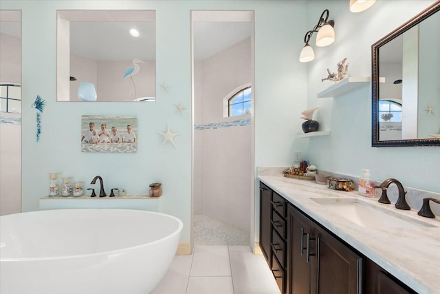 bathroom with tile patterned flooring, vanity, and shower with separate bathtub