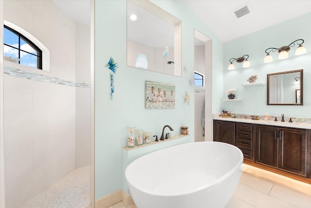 bathroom with tile patterned floors, separate shower and tub, and vanity