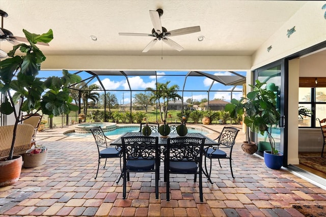 view of patio / terrace with glass enclosure, ceiling fan, and a swimming pool with hot tub