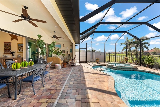 view of swimming pool featuring ceiling fan, a patio area, a lanai, and an in ground hot tub