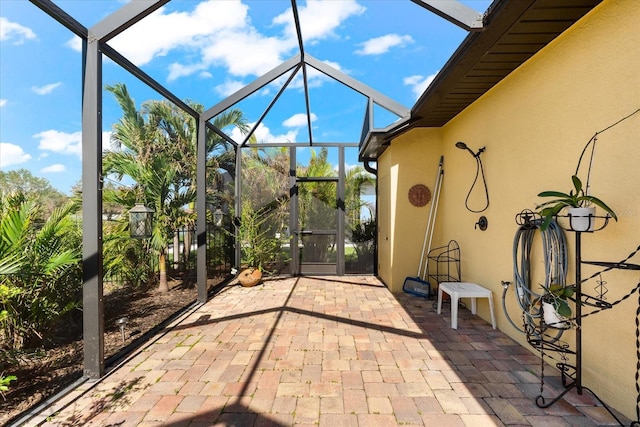 view of patio / terrace featuring glass enclosure