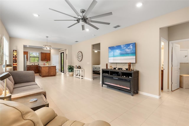 tiled living room featuring ceiling fan