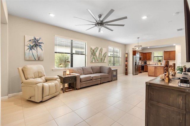 tiled living room featuring ceiling fan and a healthy amount of sunlight