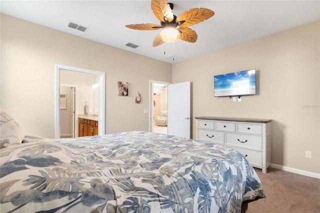 bedroom with ceiling fan, light carpet, and connected bathroom