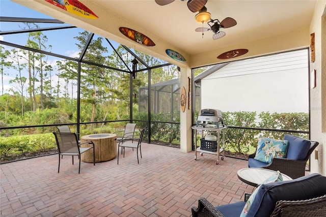 sunroom featuring ceiling fan