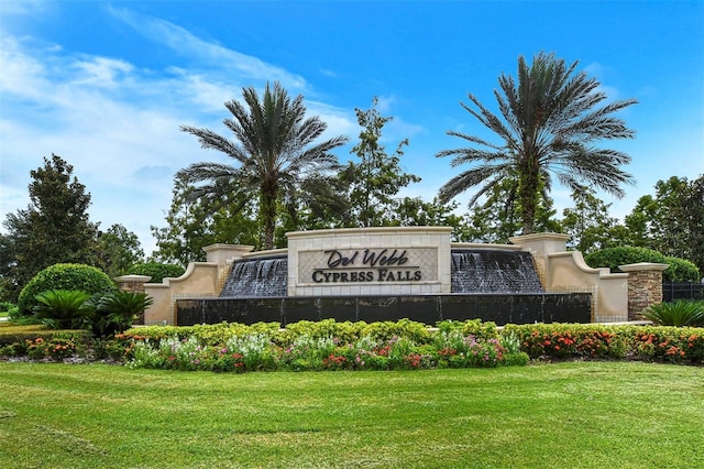 community sign featuring a lawn