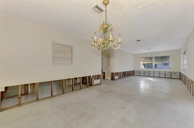 empty room featuring an inviting chandelier