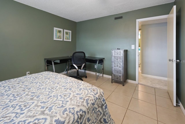 tiled bedroom featuring a textured ceiling