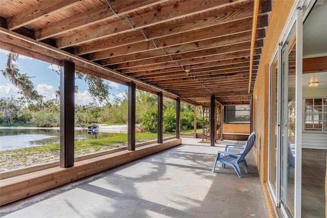 unfurnished sunroom with a water view