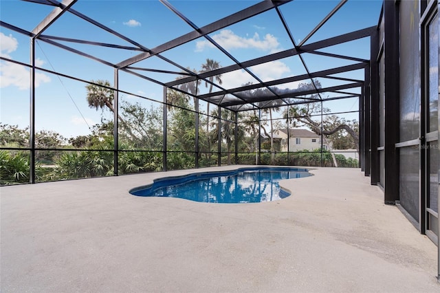 view of pool with a patio and a lanai