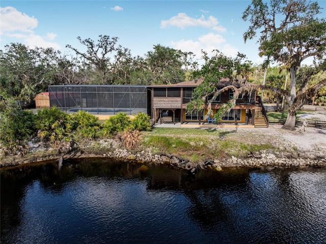 rear view of property with a water view