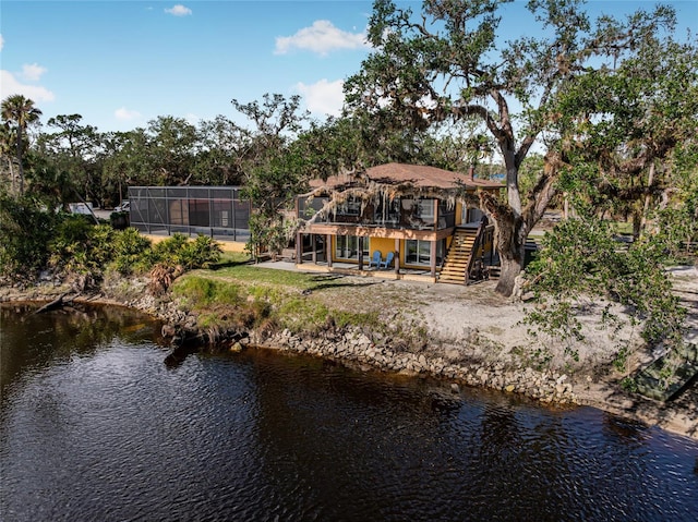 rear view of property with a water view