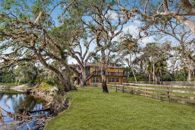 view of yard featuring a deck with water view