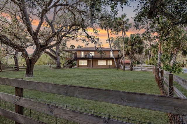 view of front of property featuring a yard and a wooden deck