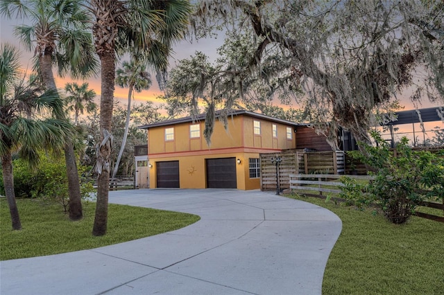 view of front of home with a lawn and a garage