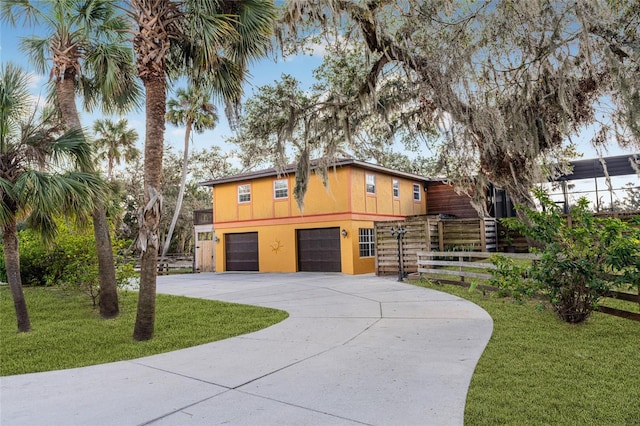 view of front of home featuring a front yard and a garage