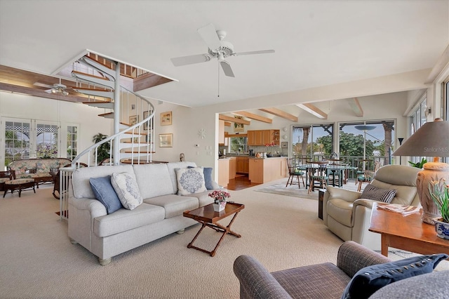 living room featuring beam ceiling, light carpet, and ceiling fan