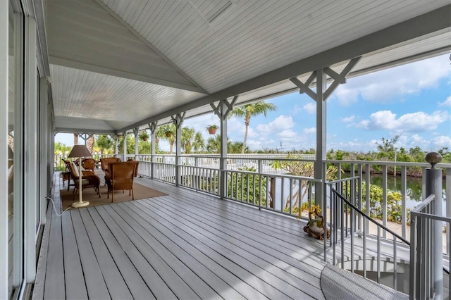 wooden terrace featuring a water view