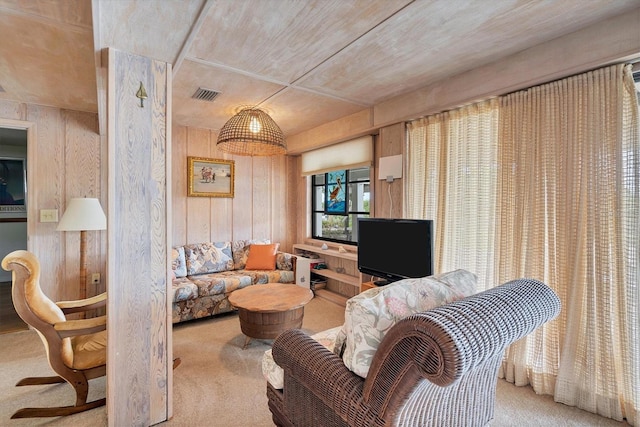 carpeted living room with wooden walls