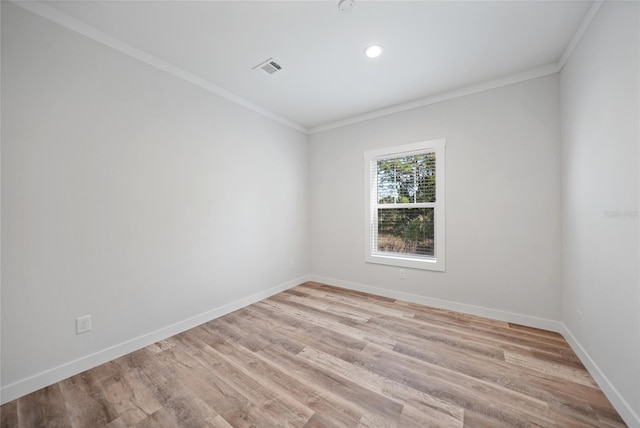 empty room with light wood-type flooring and crown molding