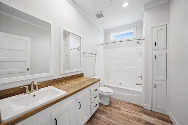 full bathroom with vanity, hardwood / wood-style flooring, crown molding, and tub / shower combination