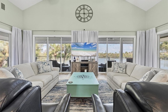 sunroom featuring vaulted ceiling and a healthy amount of sunlight